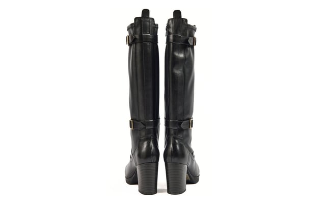 The Nitika knee boots combine chic style with practicality. Crafted from smooth black leather, theyre trimmed with gold buckles for a touch of elegance. Featuring an inside zip and elasticated panels, these boots offer easy on-and-off convenience. The platform sole and 85mm block heels provide both height and stability, making them perfect for all-day wear. With premium leather, logo detailing, and a sleek design, the Nitika boots are a must-have addition to your wardrobe.- Smooth leather upper
- Platform sole
- Inside leg zip fastening
- Gold buckle detailing with Pod branding
- Block heel height of approx. 85mm