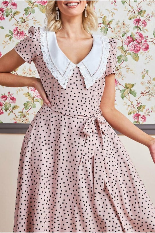 If you are looking for a cute little summer dress that is simple and stylish at the same time, then this polka dot tea dress with a collar from Goddiva is the one you want. The feminine cut accentuates your curves, while the short sleeves keep you cool on hot summer days! This classic polka dot day dress with a large collar is the perfect outfit for any summer day, from a picnic to that garden party you've been wanting to attend. This Tea Dress is designed with a high neckline, short sleeves and a fitted bodice, cinched at the waist with an eye-catching beige polka dots pattern. A style that will never not be fashionable and is an absolute essential to your summer wardrobe. This stunner of a short spring/summer dress is not only perfect for the obvious occasions, but is also a winner for date nights and of course the first thing you need to pack for your beach getaways. Team with sandals or wedges and let the dress do the talking.