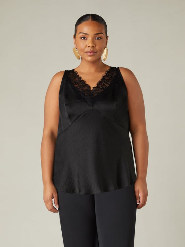 In classic black, this cami is made from the softest of satins and cut on the bias for a flattering fit. With an elegant lace neckline, it has bust seam detailing and flattering darts which create a cinched in silhouette. Its floaty, effortless shape and versatile design make this the perfect top for an evening out.