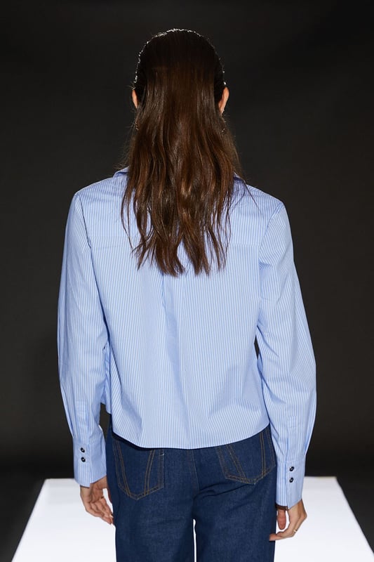Cropped boxy silhouette for a contemporary edge
        Utility-inspired design with functional chest pockets
        Crisp poplin fabric for a polished look
        Versatile collared neckline
        Part of the exclusive RUNWAY 1.8.1.8 collection
    
    Embrace effortless chic with this Runway 1.8.1.8 Stripe Poplin Cropped Boxy Utility Shirt. The cropped length and boxy fit create a modern silhouette that's perfect for the fashion-forward woman. Style this versatile piece for a range of casual occasions - pair it with high-waisted jeans and trainers for a relaxed weekend look, or tuck it into a midi skirt with ankle boots for a smart-casual ensemble. The utility-inspired design, complete with practical chest pockets, adds a touch of functionality to your wardrobe. Whether you're heading to a family gathering or meeting friends for brunch, this shirt will keep you looking stylish and feeling confident. The crisp poplin fabric ensures a neat appearance throughout the day, making it an ideal choice for those who appreciate both comfort and style in their daywear.