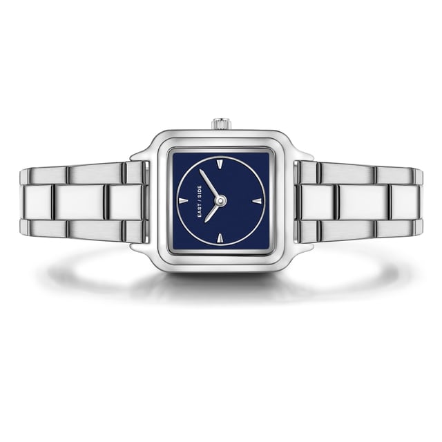 GENERAL INFORMATION:  • Targetgroup: Female  • Wristwatch: No Special Functions  • Display: analogue  • Weight of watch w/o box (gr.) - approx.: 59,0  MOVEMENT:  • Movement: Quartz  • Term of Movement: 2025  • Origin of movement: Japan  BRACELET:  • Material of bracelet/strap: Stainless steel  • Plating of bracelet/strap: None  • Finishing of bracelet/strap: Smooth  • Finishing/Decoration of bracelet/strap: None  • Clasp/Closure/Buckle: Security-folding clasp  • Color of bracelet/strap: Silver  • Length of bracelet/strap (mm) approx.: 210,0  • Width of bracelet/strap (mm) approx.: 13,8  • Style/Design of bracelet/strap: Link bracelet  • Bracelet/strap adjustable?: Yes  CASE:  • Shape of case: Square  • Size/Diameter of case in mm . approx.: 25,0 x 32,0  • Height of case in mm: 8,1  • Case material: Metal (Alloy)  • Surface of case: Polished  • Bezel/Topring: Fixed  • Finishing/Decoration of case: None  • Material of case back: Stainless steel  • Lock of case back: No screwed-in crown  • Color of case: Silver  • Coating/Plating (Case): None  • Type/Form of crystal: Flat  • Material of crystal: Mineral crystal  DIAL:  • Size jewelry care cloth: Hour, Minute  • Indices: Line indices  • Material of dial: Mother of Pearl (MOP)  • Structure/pattern of dial: Flat  • Color of dial: Blue  PUSHER, CROWN, HAND:  • Pusher: None  • Corrector: No  • Crown: No screwed-in crown  • Type of hands: Pole hand  • Luminescent (hands): No  PACKAGING & SCOPE OF DELIVERY:  • Box: Yes  • Service booklet: Yes  • Manual: Yes