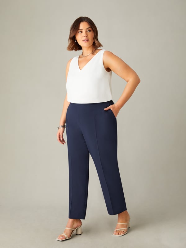 In classic navy, these trousers are cut from a woven fabric thats sturdy but comfortable to wear. With a flattering tapered leg, they have a tailored fit with side splits at the leg cuffs. A partially elasticated waist with a side zip closure adds comfort while ensuring the perfect fit, making these the perfect elevated trousers for any wardrobe.