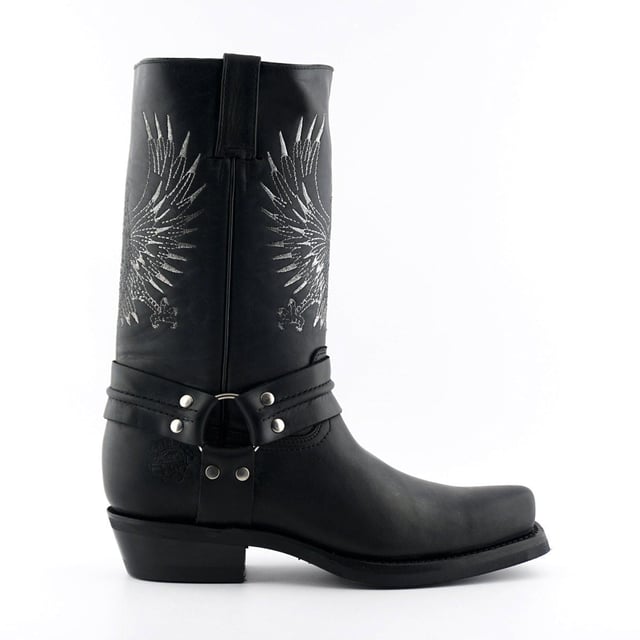 This bald eagle style pairs a vintage cowboy silhouette with an eye-catching design and imparts it upon a hard wearing and durable boot. The boot upper is crafted from leather and is embossed with a colour contrasting embroidered eagle design which is stitched onto the front and back. Additionally, a three-way ankle harness with riveted brass rings is wrapped around the boot and imbues it with extra unique quality. Other introductions to this shoe include a square toe front, comfortable leather lining, a stacked 1.5” Cuban heel and embossed branding on the outer sides. For an added durable quality, the sole of this boot is welted using the Goodyear method, which is known for providing strength and long last to shoes. • High Leg Harness Boots • Goodyear Welted sole • Shoe upper is crafted from premium leather • Features a soft leather lining • Rubber soles • Made in Mexico