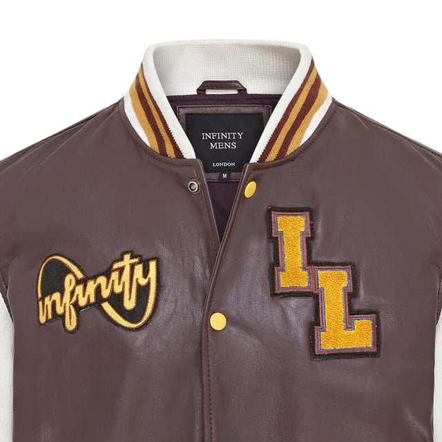 Introducing the Men's Baseball Leather Jacket, a perfect blend of classic varsity style and modern craftsmanship. This letterman bomber jacket features contrasting sleeves and a striped knit ribbed collar, waistband, and cuffs for a timeless athletic look. The press studs front closure and embroidered brand logo patches on the chest and sleeves add a touch of authenticity and flair. Designed with practicality in mind, it includes two jet pockets at the waist and two inside welt pockets for your essentials. The panelling to the back of the jacket ensures a tailored fit and superior comfort.

Contrasting sleeves for a stylish look
Striped knit ribbed collar, waistband, and cuffs for a classic finish
Press studs front closure for easy wear
Embroidered brand logo patches on the chest and sleeves for added detail
Two jet pockets at the waist and two inside welt pockets for convenience