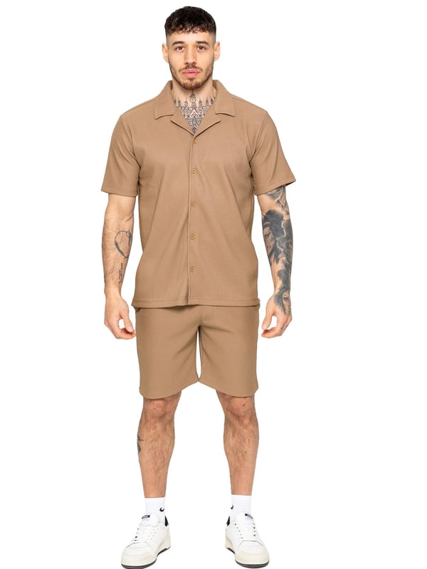 Elevate your summer style with our Enzo Milano Men's Outfit Set, including a textured ribbed revere shirt and relaxed fit shorts. Experience ultimate comfort with a button fastening and adjustable drawstring waistband, while looking effortlessly stylish with a revere collar and single back welt pocket. Made with premium fabric, this set is perfect for any occasion.