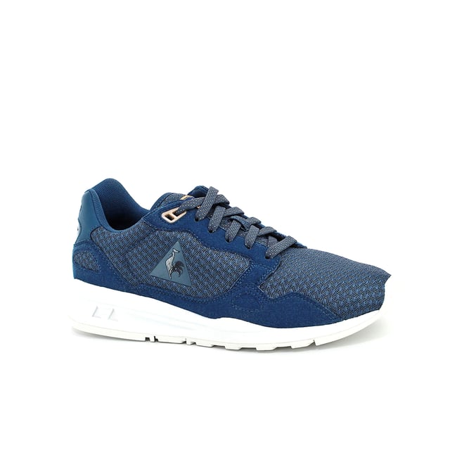 Elevate your athleisure style with the Le Coq Sportif R900 Mesh Women's Blue Trainers, a perfect blend of fashion-forward design and athletic performance. These trainers are designed to provide comfort, support, and a touch of elegance, making them an ideal choice for both sports activities and casual outings.

Key Features:

 Breathable Mesh Upper:  The R900 Mesh trainers feature a lightweight and breathable mesh upper that ensures proper ventilation, keeping your feet cool and comfortable during extended wear. This makes them suitable for various activities, including workouts and everyday wear.

 Sleek Design:  Le Coq Sportif is known for its attention to aesthetics, and the R900 Mesh trainers are no exception. The sleek design, combined with the blue colorway, offers a sophisticated look that effortlessly complements a wide range of outfits.

 Cushioned Insole:  These trainers are equipped with a cushioned insole that provides a plush feel underfoot. The added padding helps absorb impact and offers a responsive bounce, making your steps feel light and comfortable.

 Supportive Structure:  The trainers feature a supportive structure that cradles your feet, providing stability during lateral movements and ensuring a secure fit. This support is essential for various activities, including gym workouts and light running.

 EVA Midsole:  The R900 Mesh trainers come with an EVA midsole that offers excellent shock absorption properties. This feature helps reduce strain on your joints and allows you to go the extra mile with less fatigue.

 Le Coq Sportif Logo:  Look for the iconic Le Coq Sportif logo subtly placed on the trainers, adding a touch of brand recognition and authenticity to your footwear.

 Durable Outsole: