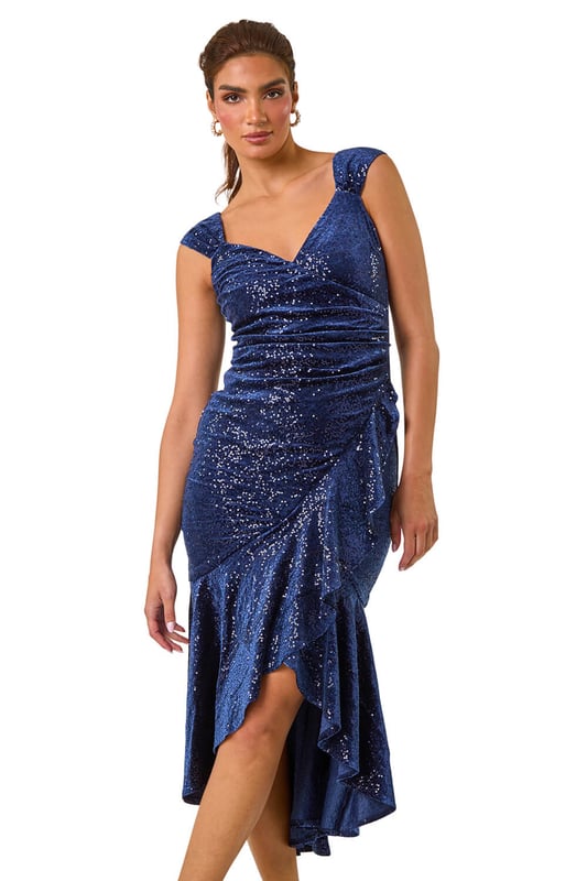 Sequin Velvet Bardot Stretch Midi Dress from Roman. Get ready to dazzle in our stunning velvet midi dress, perfect for any special occasion. The flattering bardot neckline and sleeves feature stunning velvet and sequin details, making this dress an elegant choice. Crafted from stretch woven fabric and lined for comfort, this dress falls to a midi length with a highlow hem for added flair. Finish off your look with heels and a bolero for a show-stopping look guaranteed to turn heads!
