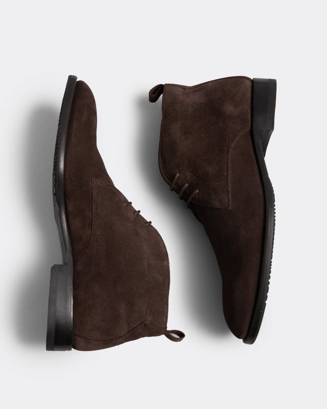 This classic chukka boot is made from suede on a formal last. The upper has clean lines and a handy back pull tab. Includes a half-leather lining and leather cushioned inner heel pad. The upper is Blake stitched to a leather sole with an additional rubber forepart on top for extra practicality.
Blake Stitched ConstructionLeather liningSuede UpperLeather sole with rubber forepartHeel pull tab
&nbsp;
&nbsp;
&nbsp;