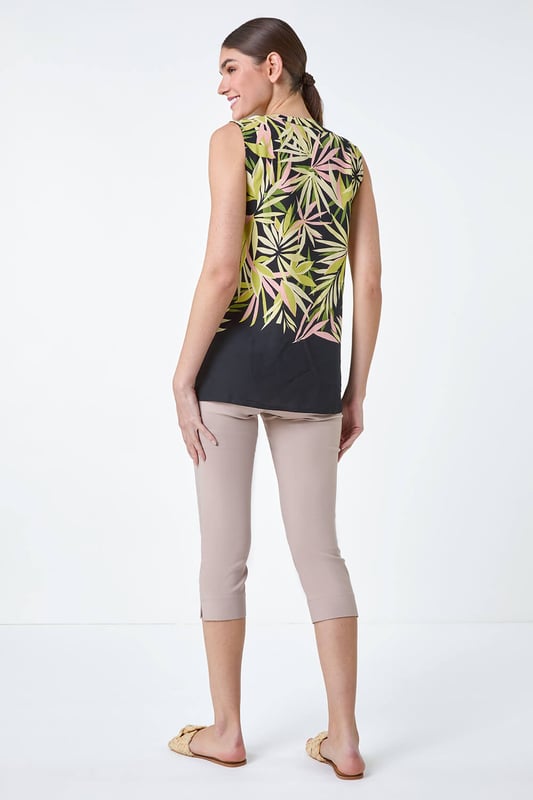 Sleeveless Leaf Print Blouse from Roman. Have fun with tropicals this season with our vibrant leaf print blouse. Cut from a smooth woven fabric, this top features a feminine notch neckline and is designed in a Summer-ready sleeveless style. Adorned in a bold palm leaf print, this piece has sweet button detail at the front for the perfect finishing touch. Pair with cropped trousers and sandals for a day of sightseeing in the city then simply add a lightweight denim jacket for dinner!