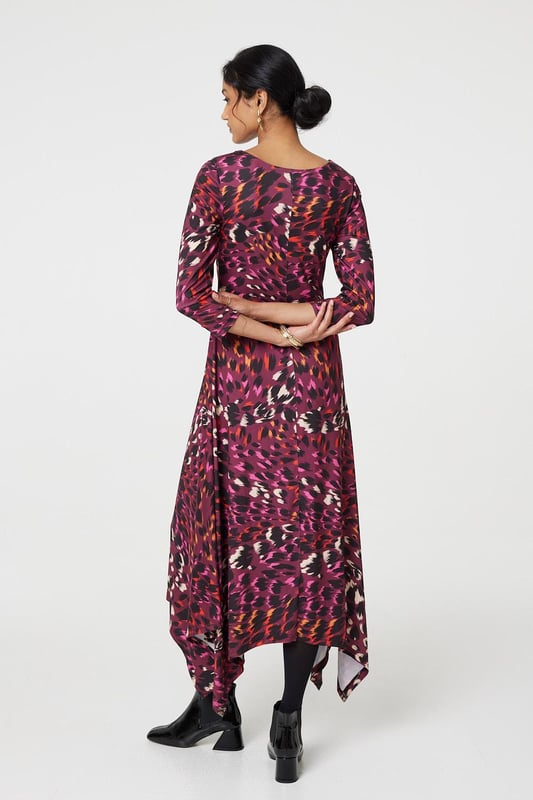 Add a vibrant animal print to your new season closet with this anima print midi dress. With a round neck, 3/4 sleeves, a hanky hem and a midi skirt. Style with strappy hees for a special event or pair with tights and block heeled boots to beat the chill.