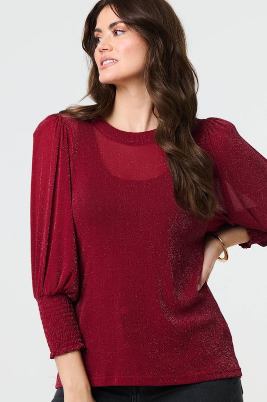 Dress for a smart-casual occasion with this glittery top. It has 3/4 puff sleeves and a hip length hem, along with a round neck and a relaxed fit. Just pair with fitted jeans and heels for the perfect laid-back occasion wear outfit.