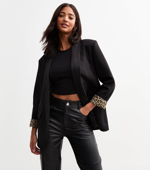 Elevate your style with our sleek Black Contrast Animal Edge to Edge Blazer. Stand out with its unique animal print contrast, perfect for the fashion-forward woman. This versatile blazer can be dressed up or down, making it a stylish addition to any wardrobe.