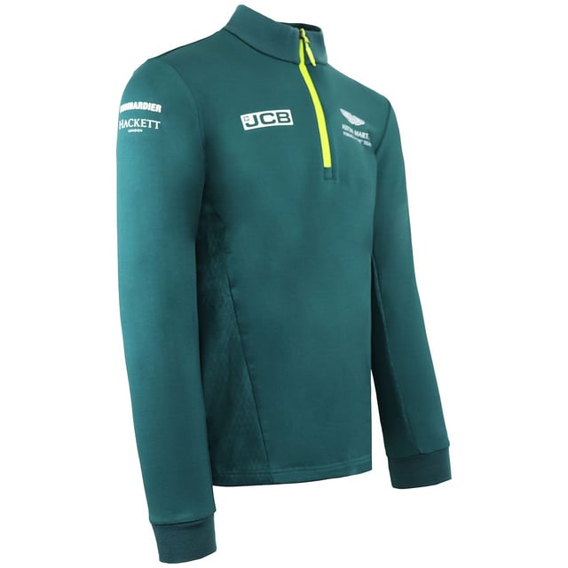 La camiseta Aston Martin F1 Official Team Men's Green Midlayer es una prenda elegante y funcional diseñada para los entusiastas de la Fórmula 1 y los seguidores del Aston Martin Cognizant F1 Team. Estas son las principales características de esta capa intermedia para hombre:

 Mercancía oficial del equipo:  Esta capa intermedia es mercancía con licencia oficial del equipo Aston Martin Cognizant F1, lo que garantiza que representa la marca y la calidad del equipo.

 Diseño verde:  La capa intermedia es predominantemente verde, lo que refleja el color característico del equipo y añade un toque deportivo y elegante a tu atuendo.

 Estilo de la capa intermedia:  Una capa intermedia suele estar diseñada para proporcionar una capa extra de calidez y comodidad sin ser demasiado voluminosa. Es ideal para llevar debajo de una chaqueta o encima de una camiseta.

 Marca del equipo Aston Martin F1:  La capa intermedia suele llevar la marca del equipo, incluidos logotipos y otros elementos asociados a la escudería de Fórmula 1, mostrando tu apoyo y pasión por el equipo.

 Cierre con cremallera: Suele incluir un cierre frontal con cremallera, que permite llevarla fácilmente y regular la temperatura.

 Construcción de calidad:  Los artículos oficiales de Fórmula 1 son conocidos por su calidad, y esta capa intermedia está diseñada para mantener su forma y estilo con el uso regular.

 Uso versátil:  Tanto si asistes a una carrera de F1 como si la ves desde casa o simplemente sigues con tu día a día, esta capa intermedia ofrece calidez y estilo, permitiéndote expresar tu pasión por el deporte y el equipo.

 Uso diario:  Aunque es perfecta para los eventos y carreras de F1, esta capa intermedia también es adecuada para el uso diario, añadiendo un toque deportivo y de moda a tu atuendo diario.