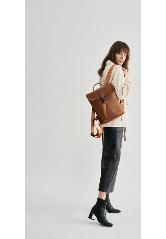 This contemporary style is perfect for those seeking practicality with style. Crafted with smooth leather, the bag oozes premium quality with a flap over front with gunmetal clip buckle and a leather grab handle. The premium nylon webbing shoulder straps are adjustable, providing comfort for the wearer as well as being durable. Inside reveals signature Smith & Canova lining and zip and fold pockets for any valuables. The exterior features a Smith & Canova debossed logo as well as an extra zip pocket. Features: , Smooth leather, Smith and Canova debossed logo, Flapover front with clip buckle fastening and nylon webbing, Gunmetal hardware, Leather grab handle, Adjustable premium nylon webbing shoulder straps, Smith and Canova signature lining, Internal zip and fold pockets, Padded 9 inch tablet slip pocket with Velcro tab fastening, External vertical zip pocket on the back, Smaller size Style Ref: 93056 TAN