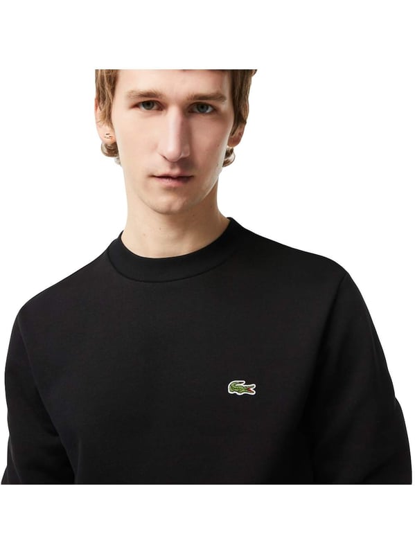 Solid-colored sweater with a round neckline, ribbed cuffs and subtle logo patches in a regular fit.