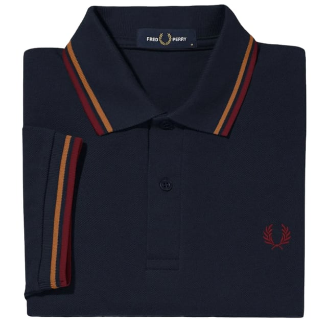 The Twin Tipped Fred Perry Polo Shirt by Fred Perry is a short sleeved polo shirt that has been made from Fred Perry's classic cotton piqué, in a contemporary adaptation of Fred's famous streamlined fit. Available in a diverse range of colourways - each with their own unique story. Featuring the signature Fred Perry wreath logo to the chest and twin tipping to the collar and cuffs.