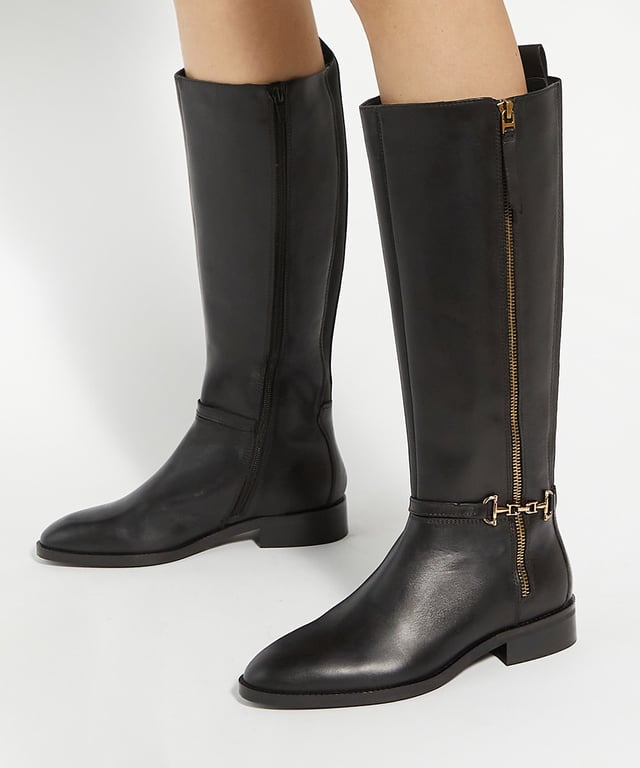 Dune Ladies Taylyn - Riding Boots With Signature Buckle Detail Crafted from the finest leather and featuring signature buckle detail, these timeless knee-high boots will make an effortless addition to your wardrobe. Designed with a side zip, this round-toe silhouette rests on a low heel, offering a timeless aesthetic with a contemporary touch.