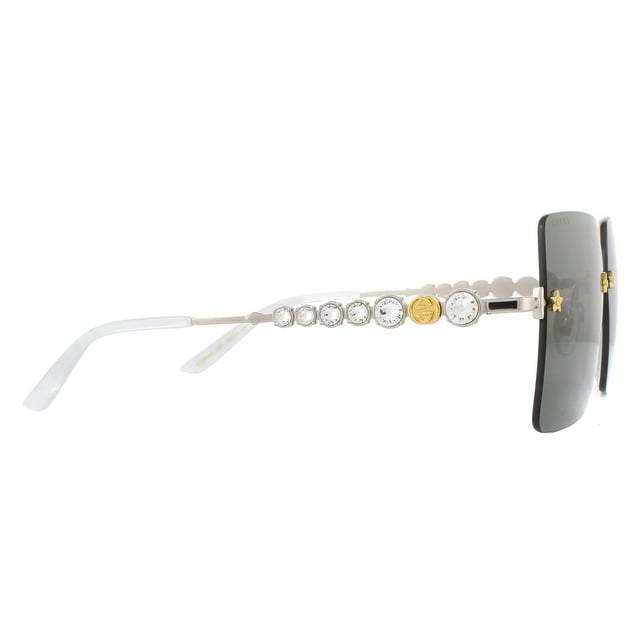 Gucci Sunglasses GG0644S 001 Silver Greyare incredibly glamorous with the large rimless square lenses set into the frame with star details screws. Leage crystal feature down the temples alongside the GG logo to great effect..