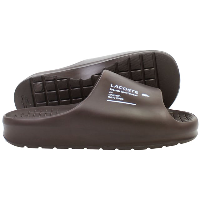 The Lacoste Serve Slide 2.0 223 2 CMA Men's BrownÂ Sliders deliver timeless style and exceptional comfort, making them a versatile option for casual wear, poolside lounging, or beach outings. These sliders feature a sleek design with iconic branding for a polished yet relaxed look.
Â 
Key Features:
Ergonomic Footbed: 

Contoured for superior comfort and support, ideal for extended wear.


Durable Synthetic Strap: 

Embossed with the signature Lacoste crocodile logo, adding a stylish and recognizable touch.


Slip-On Design: 

Easy to wear, offering convenience for relaxed occasions or quick outings.


Textured Rubber Outsole: 

Ensures reliable grip and traction on both wet and dry surfaces.


Lightweight Construction: 

Reduces fatigue, making them perfect for all-day comfort.


Water-Resistant Materials:

Designed to handle pool, beach, or shower environments without compromising durability.


Classic BrownÂ Colorway:Â 

A versatile and timeless design that pairs effortlessly with casual or sporty outfits.


Â 
The Lacoste Serve Slide 2.0 223 2 CMA Men's BrownÂ Sliders are a must-have for laid-back footwear, offering a combination of comfort, durability, and understated style for any relaxed occasion.
Â 
Â 
Â 