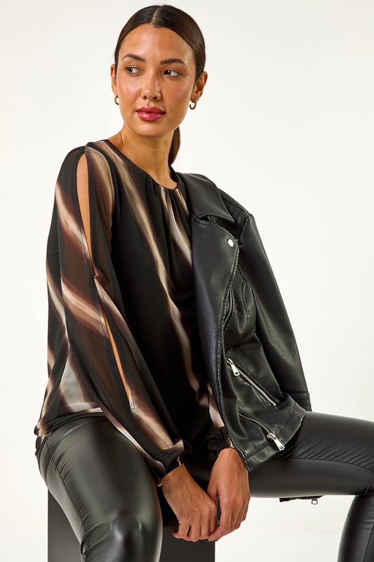 Stripe Print Mesh Overlay Top from Roman. Add a touch of elegance to your Autumn/Winter wardrobe with this chic mesh overlay top featuring an all over stripe print. With long sleeves and an elasticated cuff, this piece is designed with a classic round neck and falls to a flattering hip length. Perfect for layering over a camisole or fitted top, pair with tailored trousers and heels for a sophisticated look that transitions seamlessly from day to night!