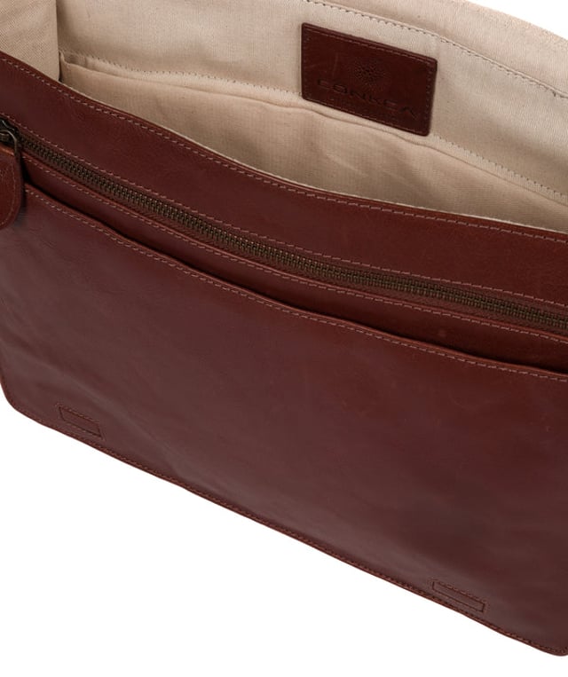 Handcrafted from full-grain natural leather, the 'Zico' messenger bag from Conkca London comes with a robust finish. The handsome accessory features a fold-over top secures a spacious central compartment which is lined with natural, untreated 100% cotton lining alongside rustic metal fittings and zips. Ample storage space is provided by a padded laptop pocket on the interior. Comes with an adjustable strap with a maximum drop length of 70cm and adorned with the handsome Conkca leather label.