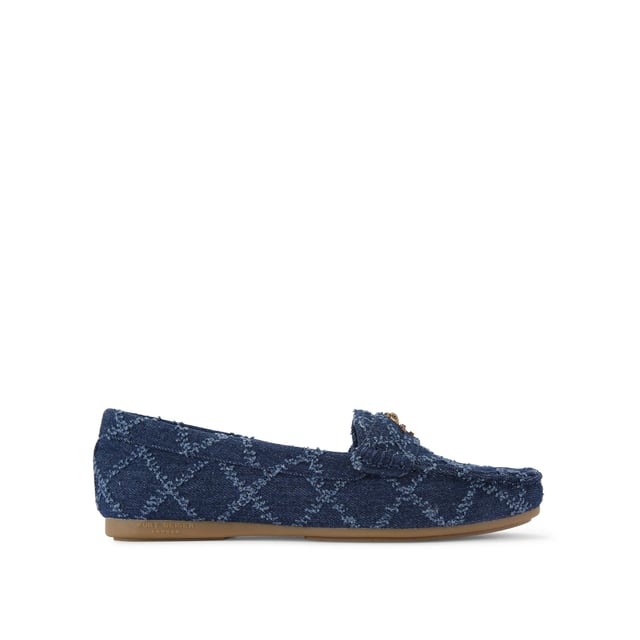 The Kurt Geiger Greenwich Moccasin slip-on loafer features a blue denim upper with frayed diamond quilting design. There is antiqued brass branding on the front alongside micro eagle head.