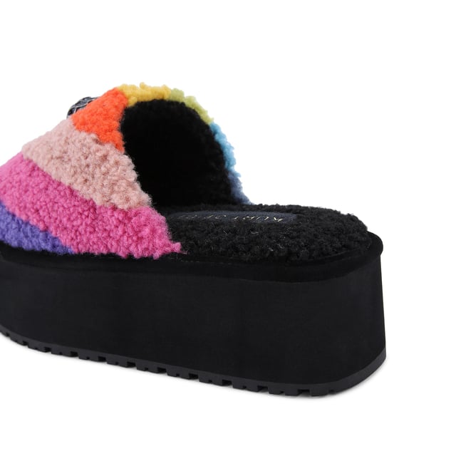 This Kurt Geiger Kensington Pump Slippers has a faux shearling upper in a rainbow stripe design. There is an antiqued silver eagle head with rainbow crystals on the toe. Sole height: 5cm.