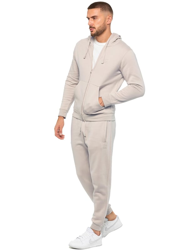Be ready to conquer any day in the Enzo Mens Zip Hoodie Tracksuit Set. With its comfortable regular fit, long sleeve zip hoodie with cuffed wrists, and adjustable drawstrings, this set will have you looking and feeling your best. The joggers feature the iconic EZ logo and also have a regular fit with cuffed legs and an elasticated waistband with a drawstring for a custom fit. The set is functional with 2 side slash pockets and a single welt back pocket, making it perfect for both casual and work wear.