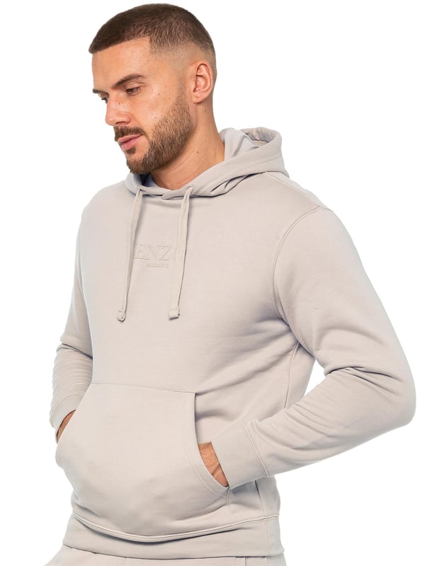 Introducing the Enzo Men's Pullover Hoodie, a versatile addition to your wardrobe. Crafted with comfort and style in mind, this hoodie features cuffed wrists and an adjustable drawstring hood for a personalized fit. Complete with a convenient kangaroo pocket, it offers both functionality and fashion. Finished with Enzo print on the chest