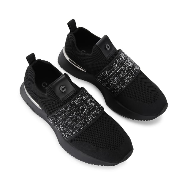 The Carvela Flare Sparkle trainer is a slip-on style with a black knitted upper. There is a crystal encrusted black fabric strap across the foot. The sole is chunky in black.