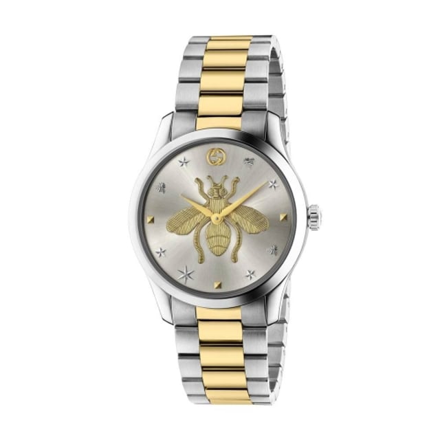 Gucci G-Timeless Bracelet Watch YA1264131. This model has stainless steel 38mm case featuring silver sunbrushed dial with central yellow gold bee motif. This model has a quartz movement and is water resistant to 50 metres. Presented on a stainless steel and yellow gold PVD bracelet with deployment fastening.