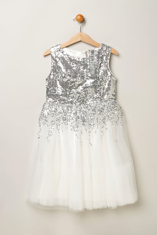 Step into magic with this sequin waterfall dress from Luna Moon by Miss, featuring a stunning large bow at the back. Watch her dazzle in this mesmerizing ensemble, effortlessly transitioning from shimmering sequins to a flowing tulle skirt. Perfect for special occasions, this dress promises to charm wherever she goes. This dress is the perfect blend of sparkle and sophistication.
