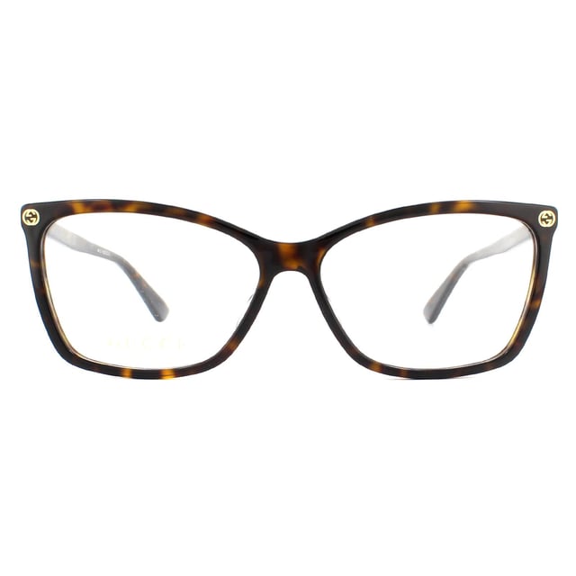 Gucci Glasses Frames GG0025O 002 Dark Havana Women are a gorgeous cat eye style crafted from lightweight acetate and features the interlocking Gucci GG logo on the frame corners, and the bee logo on one temple tip.