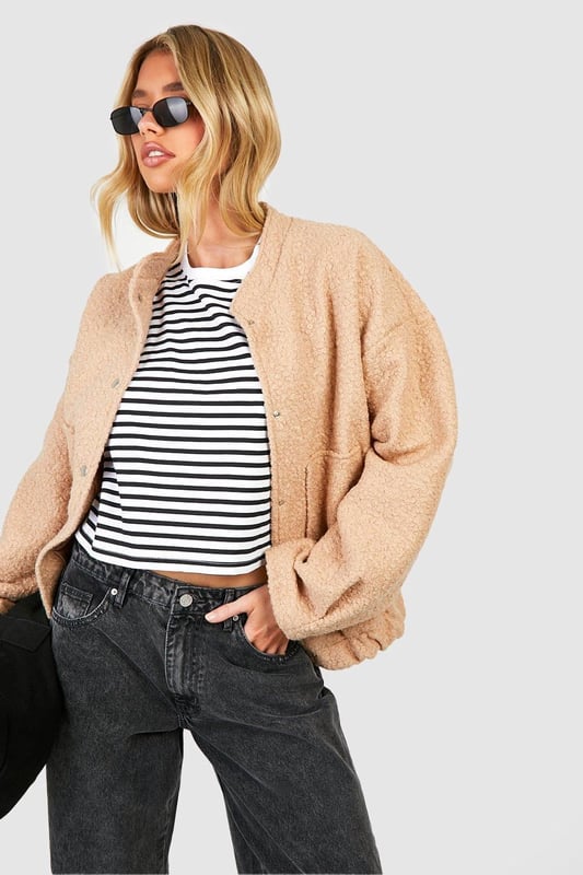 Keep things casual but always on-trend with a piece of outerwear perfection, the bomber jacket. A light jacket featuring a gathered, ribbed waistband and matching cuffs, a bomber jacket is versatile, timeless, and the perfect way to edge up your casual wear. Wear your new women's bomber jacket with a shirt and stripe joggers for the hottest look of the moment: sports luxe, or layer a varsity jacket over a t shirt dress for a fresh new-season look.Style: Bomber JacketFabric: Wool LookLength: RegularSleeve Length: Long Sleeve