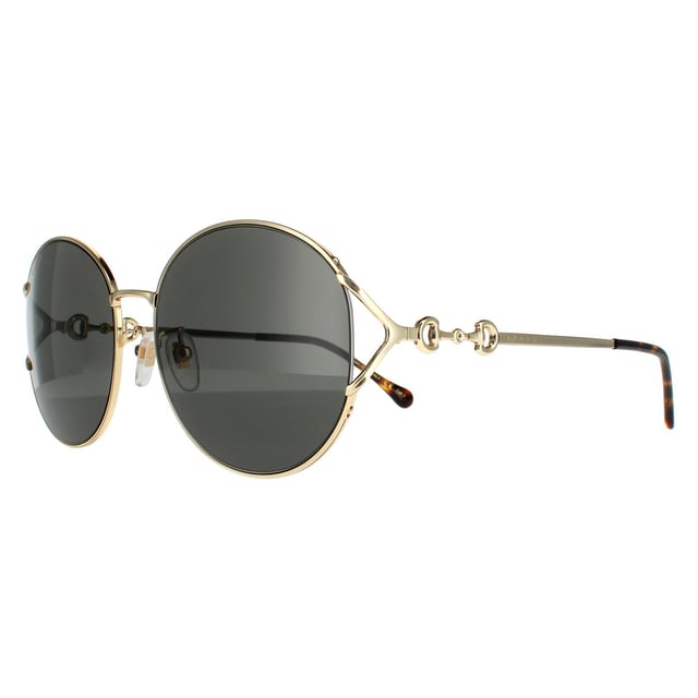 Gucci zonnebrillen GG1017SK 001 Gold Gray zijn een ongelooflijk glamoureus randloos ronde frame. De verstelbare neuskussens en plastic tempeltips zorgen voor een comfortabele de hele dag fit. De tempels geven het Gucci -logo voor merkherkenning