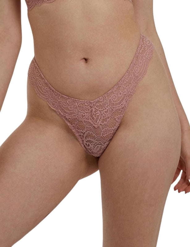 The Ariana range by Playful Promises brings this flirty thong that is perfect for adding a cute feeling to your daily life. Covered in semi-sheer lace it lays softly against your body. It has an extremely flattering shape with a high-cut leg that creates the illusion of longer legs whilst the mid-rise waist and minimal rear coverage showcase your incredible figure.  Flirty thong, Semi-sheer feminine lace, High-cut leg, Mid-rise waist and minimal rear coverage, Elasticated waistband, Comfortable fit, Country of origin: China, Composition: Main: 89% Polyamide | 11% Elastane, Composition: Gusset Liner: 100% Cotton, Listed in UK sizes.   Thong