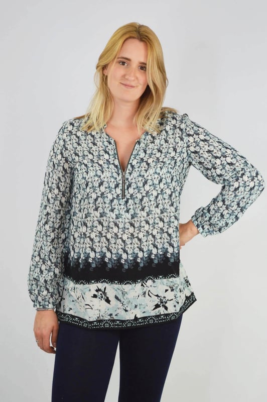 Keep your everyday look stylish with this relaxed fit top. Wear loose with leggings or belted over your favourite jeans. Made from a lightweight woven fabric, with long zip neck and long sleeves with single button cuff.

100% Polyester
Silky Stretch
Sizing: generous 
Long Length
33" Shoulder to Hem
Straight Hem