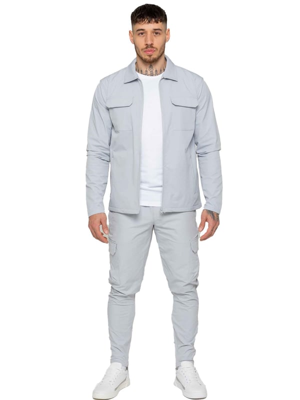 Enzo Mens Cargo Shacket Tracksuit Set. Zip Up Cargo Collared Shacket. Features Front Upper Cargo Pockets, Long Set in Sleeves, Stitched Trims on Cuff &  Hem. Set Completed With Cargo, Straight Leg, Slim Fit Trousers. Elasticated Waistband With Adjustable Drawstring. Two Slash Side Zip Pockets, Single Back Welt Pocket, Two Outer Cargo Pockets. Crafted With Premium Stretch Material. Modern, Stylish & Comfortable.