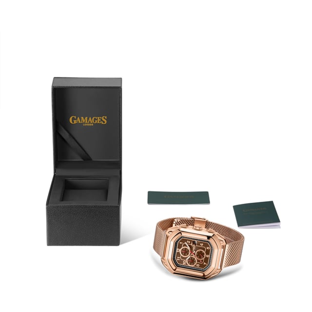 Status is embedded in British culture. From the monarchy to lordships and landowners, there is a distinct association of class and sophistication. Yet status also denotes a manner of chivalry and is considered the way one should act for themselves and others. The Gamages Of London Limited Edition Hand Assembled Galahad Status Automatic Rose men’s watch draws influences from the epitome of such chivalry. Sir Galahad of King Arthur’s round table, who was considered the most perfect of Knights for his gallantry. 

Its 163 part 20 jewel hand assembled movement operates the timepiece with careful precision and grace. The forest-green dial is detailed with Minutes, Day, Date and  Month counters, reminiscing on Galahad’s quest to locate the Holy Grail. Bordering these counters, there is a luminous hands which match the illuminating miracles Galahad is said to have performed.

The rose gold Milanese bracelet mimics the chainmail armour which Galahad bravely donned before battle, and the stainless steel caseback is engraved with the Gamages Of London logo. Finally, the robust yet elegant design captures Galahad’s purest essence and ensures his legend lives on.
Model Specifications 
Automatic Movement 
163 Part 20 Jewel Hand Assembled Movement
Brown Dial
Rose Gold, Case
Luminous Hands
Minutes, Day, Date & Month Counter
Rose Gold, Milanese Bracelet
Logo Engraved Stainless Steel Caseback 
Rose Gold Ip Case  

12 Hour Analogue
Water Resistant 30M
Scratch Resistant Mineral Glass
5 Year Warranty
Nickel Free & Hypoallergenic Ip Plating

Watch Dimensions
Case Diameter 51 Mm
Case Thickness 15 Mm
Lug Width 24 Mm
Strap Width 22 Mm
Strap Length 195 Mm
Weight 135G
