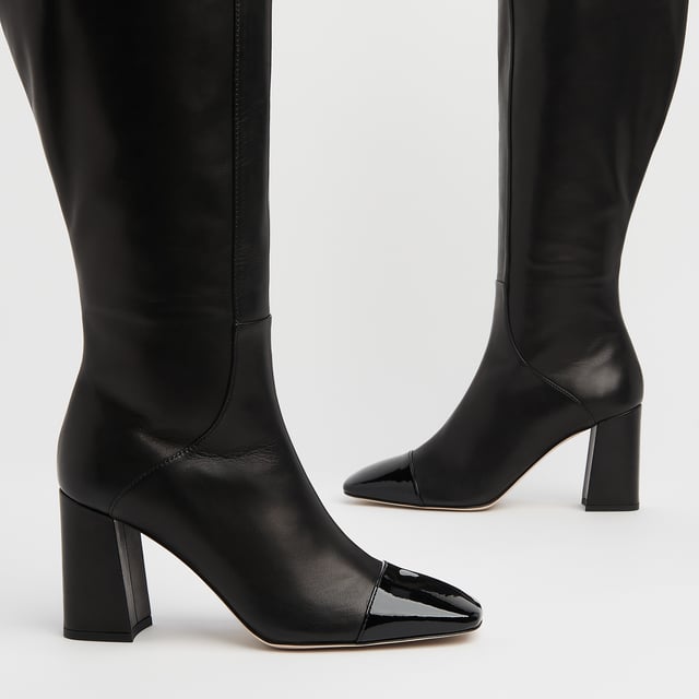 LK Bennett Bess Knee Boots, Black A classic knee boot with a difference, our Bess boots take on the season's toe cap trend. Crafted in Italy from beautifully-soft black calf leather, they have a square toe with a black patent toe cap, seam detail to the front, an inside zip and a leather-covered squared block heel. They're perfect with Sixties-inspired mini dresses and Seventies-style midi dresses.
