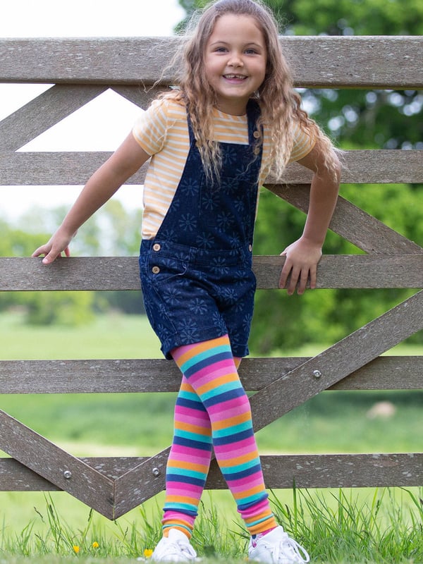 100% organic cotton |  Light navy etched smiley sun design |  Navy blue |  Lightweight denim fabric |  Apple enzyme washed for a soft hand feel |  Adjustable straps with coconut buttons |  Coconut button side fastenings |  Side, back and front bib pockets |  Short legs |  With turn-ups |  Made in Turkey |  Machine washable at 40 degrees, or at 30 degrees to be kinder to the planet
