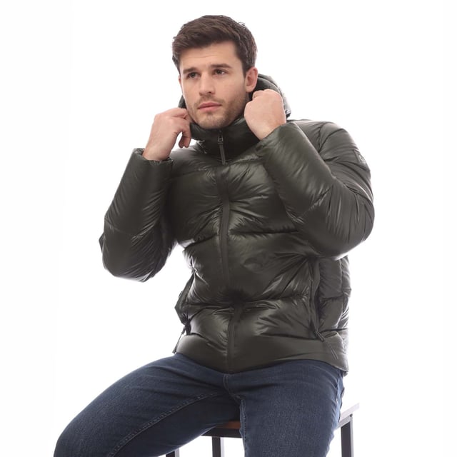 Mens Belstaff Down Filled Ripstop Resolve Jacket in green.- Hood and hem drawcord.- Water resistant centre front zip.- Zip fastening hip pockets.- Silicone phoenix badge on left sleeve.- High-shine  100% recycled nylon in a micro ripstop construction.- High performance  lofty  ultralight and highly insulating down jacket style.- Water repellent.- 750 fill power down.- 100% RDS certified down and feather (IDFL CERT TE-00103785) with PFAS free water-repellent finish.- High-shine  100% recycled nylon in a micro ripstop construction.- 100% Polyamide.- Ref: 105161TLGRN