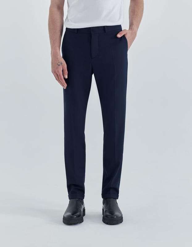 This navy trousers suit has zip and button fastening.