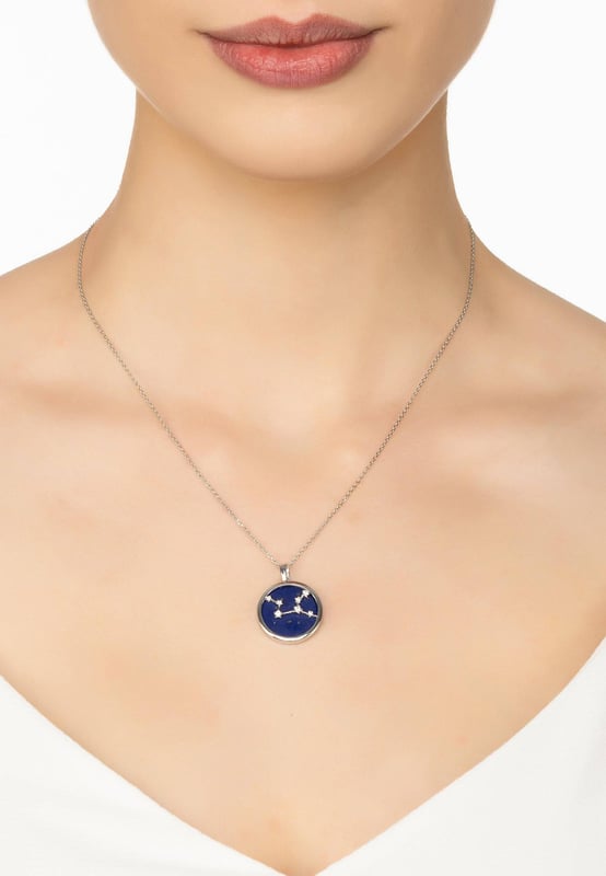 Look no further than this beautiful Zodiac Lapis Lazuli Gemstone Star Constellation Pendant Necklace to make a dazzling statement! This gorgeous necklace is crafted in the finest 925 sterling silver, encasing a disc of Lapis Lazuli and handset with shimmering white cubic zirconia. It features a stunning star constellation on its face, which pairs perfectly with the deep blue hue of lapis lazuli for an eye-catching effect. Plus, to make it even more special, it includes an engraved name of your star sign on the reverse along with cut-out stars.Virgos, born between August 23 and September 22, are known for their analytical minds, practicality and attention to detail. They are often perfectionists who strive for the highest standards of excellence in all areas of life. Virgos have an eye for seeing the big picture and also understanding how small details fit into it.It's perfect for every fashionista who loves delicate jewellery that stands out from the crowd. Enjoy the versatility of being able to wear this pendant at a length to suit you due to its 40cm plus 5cm (with adjuster) length. Meanwhile, its lightweight design at just 5.3 grams ensures you won't be weighed down when wearing it all day long.We think you'll be absolutely delighted with this Zodiac Lapis Lazuli Gemstone Star Constellation Pendant Necklace Silver! With its distinctly fashionable yet timeless design and quality craftsmanship.