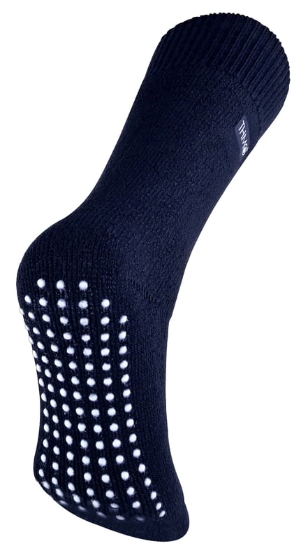 THMO thermal slipper socks have been made with a heavy bulk acrylic yarn with extreme thermal qualities. They have been double brushed on the inside to maximise warmth by trapping warm air and keeping it close to your feet. This brushing also softens the inside of the sock making it a great choice for indoor relaxing. These thermal socks also feel like they are seamless with a neat hand-linked toe. The ribbed welt at the top of the sock has been designed to rest to the natural contours of your legs. This wide soft top provides all day comfort and will reduce the chances of nasty constriction rings developing around your legs. The THMO badge is also heat transferred onto the side of the sock. This is the THMO slipper version for the thermal socks. An anti slip grip has been designed onto the foot of the sock in order to prevent you from slipping on surfaces such as hard wooden floors or kitchen tiles. It is a simple but effective dotted design on the foot of the sock. This is very handy if you are using our thermal socks to lounge around the house instead of going outdoors and using them for walking and hiking. These men's THMO thermal slipper socks are available in 2 colours including black and navy, the grip is a white dotted design. They are a size 6-11 UK 39-45 Eur 7-12 US and they are made from 93% Acrylic, 6% Polyamide, 1% Elastane. They are also safely machine washable.