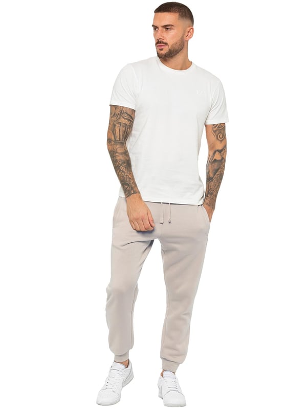 Experience ultimate comfort in our Enzo Mens Regular Fit Joggers. Made with a soft brushed back inner fleece lining, these joggers are perfect for casual wear. The cuffed leg design and elasticated waist with drawstrings provide the perfect fit. With 2 side slash pockets, you can easily carry your essentials.