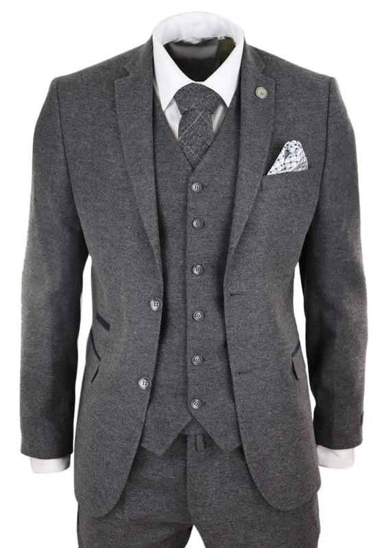 A grey suit is a key staple in every mans wardrobe and this one is no exception to this unwritten rule. Sharp, sleek and sophisticated, look the part with this premium 3 piece grey wool tweed suit, that features a slim fit cut, with a closer fit across the chest and narrower tailored trousers. the two-button jacket hangs beautifully and has a half canvas construction that moulds to your body shape the more you wear it. Contrasting velvet pocket piping, buttoned cuffs and a single back vent lend the suit a classic touch of refinement. A matching tweed waistcoat completes the 3-piece with a single breasted down style with classic tailored pockets and a back adjuster to ensure you can create your ideal fit. The suit is evergreen and contemporary at the same time and allowing you to look the best all day. Pair it with a matching waistcoat, a white shirt and shoes for a dapper finish.