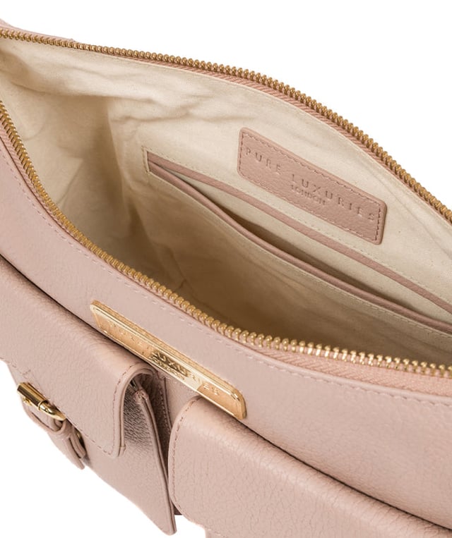 Crafted from leather that has soft pebble grain finish, the 'Jenna' shoulder bag from Pure Luxuries London comes with eye-catching gold-coloured fittings. The zip-over top secures a 100% cotton lined compartment, complemented by two internal pockets along with three external pockets that provide on-the-go storage; two of which are fastened with mock buckle press-studs. Comes with an adjustable matching leather strap and is adorned with the gold-coloured Pure Luxuries London charm and logo.