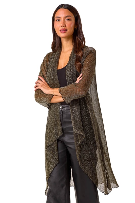 Shimmer Plisse Longline Kimono from Roman. Wrap up in style this Autumn/Winter with this gorgeous plisse longline kimono. Featuring a striking chevron metallic print and crafted from stretch plisse fabric, this kimono exudes elegance. With a flattering longline length, long sleeves, and an edge to edge design, it's perfect for layering over any outfit. The waterfall front adds a touch of sophistication. Pair it with a simple t-shirt and PU trousers for a chic and on trend look!