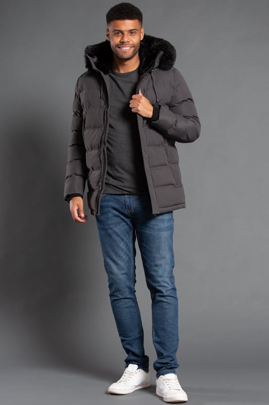 This longline hooded padded jacket from Nines by Kensington Eastside will ensure you are kept warm on colder days. Features faux fur hood with toggles and inside fur lining, zip and popper fastening, two large zip fastening pockets with divider, and ribbed elasticated cuffs for extra comfort.